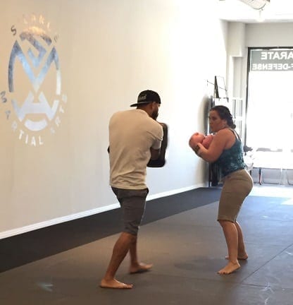 Tina Austing work the kicking pad in Muay Thai Dutch Kickboxing class