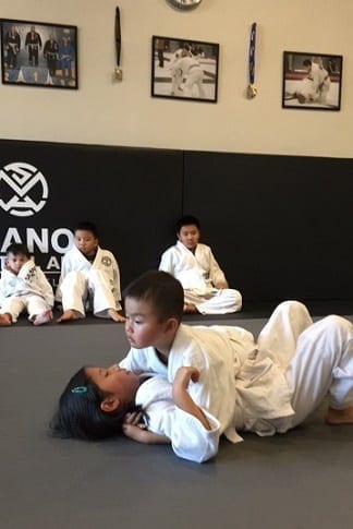 Sammi with teammate Colin practising her BJJ mount escape