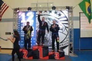 Ismael on the podium taking gold at the NABJJF Jiu-Jitsu competition at blue belt.