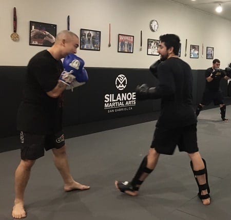 Dan Kang in a Muay Thai Kickboxing sparring match ready to punch and kick at Silanoe Martial Arts