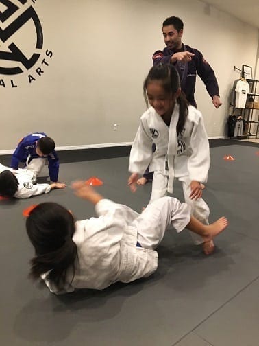 Allison enjoying herself at kids Jiu-Jitsu class under watchful eye of Professor Gino Silanoe