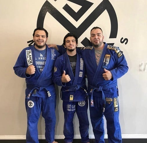 The Aguila Family in front of our logo wall in our Alhambra San Gabriel location